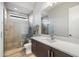 Modern bathroom with a glass shower, white countertops, and dark wood cabinetry at 2843 E Los Gatos Dr, Phoenix, AZ 85050