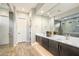 Modern primary bathroom with dual vanities, a large mirror, and a glass-enclosed shower at 2843 E Los Gatos Dr, Phoenix, AZ 85050