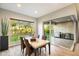 Bright dining room with a marble table, four chairs, outdoor views, and sliding glass doors to the patio at 2843 E Los Gatos Dr, Phoenix, AZ 85050