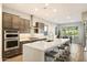 Modern kitchen with a large island, stainless steel appliances, and dark wood cabinetry at 2843 E Los Gatos Dr, Phoenix, AZ 85050