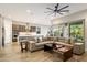 Open-concept living space with a large gray sectional sofa and a view to the kitchen and dining area at 2843 E Los Gatos Dr, Phoenix, AZ 85050