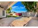 Well manicured backyard with artificial grass, patio and seating area at 328 E Ivy St, Mesa, AZ 85201