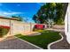 Lush backyard with artificial turf, patio and drought tolerant landscaping at 328 E Ivy St, Mesa, AZ 85201