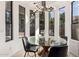 Bright breakfast nook featuring a glass table, black chairs and large windows at 328 E Ivy St, Mesa, AZ 85201