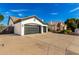 Three-car garage of a charming home with a long driveway and neat landscaping at 328 E Ivy St, Mesa, AZ 85201