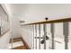 Hallway with a hardwood floor, white railings and a ceiling fan at 328 E Ivy St, Mesa, AZ 85201