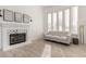 Cozy living area with a decorative fireplace, plantation shutters, and wood-look tile at 328 E Ivy St, Mesa, AZ 85201