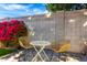 Cozy backyard patio with a small bistro table and two chairs amid blooming bougainvillea at 328 E Ivy St, Mesa, AZ 85201