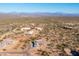 Aerial view of a desert home with a large lot size in a mountain community at 34515 N 142Nd St, Scottsdale, AZ 85262