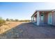 This backyard features a patio area, desert landscape, and a view of the blue sky at 34515 N 142Nd St, Scottsdale, AZ 85262