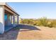 The backyard features a covered patio and desert landscape with bushes and a view of neighboring houses at 34515 N 142Nd St, Scottsdale, AZ 85262