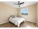 This naturally lit bedroom features tile floors, light-colored walls, a window view, and a ceiling fan at 34515 N 142Nd St, Scottsdale, AZ 85262