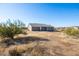 A single-story home featuring desert landscaping and a covered patio, blending seamlessly with its natural surroundings at 34515 N 142Nd St, Scottsdale, AZ 85262