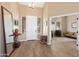 Inviting foyer with hardwood floors, a statement mirror, and a glimpse into the living spaces at 34515 N 142Nd St, Scottsdale, AZ 85262