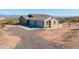 Modern home with attached three-car garage, ample parking space, and low-maintenance desert landscaping at 34515 N 142Nd St, Scottsdale, AZ 85262