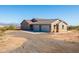 Beautiful desert home featuring a spacious three-car garage and paved driveway at 34515 N 142Nd St, Scottsdale, AZ 85262