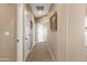 A hallway with tile flooring, neutral paint, white trim, and doors provides access to various rooms in the house at 34515 N 142Nd St, Scottsdale, AZ 85262