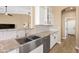 A farmhouse sink with stainless steel appliances, granite countertops, and white cabinets enhance this contemporary kitchen at 34515 N 142Nd St, Scottsdale, AZ 85262