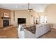 Inviting living room with a stone fireplace, comfortable seating, and an open layout at 34515 N 142Nd St, Scottsdale, AZ 85262