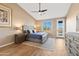 Inviting bedroom featuring a ceiling fan, wood-look tile floor, and private patio access at 34515 N 142Nd St, Scottsdale, AZ 85262