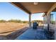 Covered patio with desert views, a barbecue grill, comfortable chairs, and an outdoor heater at 34515 N 142Nd St, Scottsdale, AZ 85262