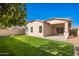 Backyard with well-maintained grass and small plants, providing a beautiful outdoor space at 379 W Dragon Tree Ave, San Tan Valley, AZ 85140