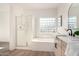 Well-lit bathroom featuring a glass-enclosed shower and soaking tub, as well as a stylish sink and vanity at 379 W Dragon Tree Ave, San Tan Valley, AZ 85140