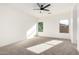 A sunlit bedroom with carpet flooring and two windows, creating a cozy and bright space at 379 W Dragon Tree Ave, San Tan Valley, AZ 85140