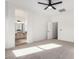 Bright bedroom featuring neutral carpet, a ceiling fan, and an ensuite bathroom with a double sink vanity at 379 W Dragon Tree Ave, San Tan Valley, AZ 85140