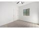 Bright bedroom featuring neutral carpet, a ceiling fan, and a window bringing in natural light at 379 W Dragon Tree Ave, Queen Creek, AZ 85140