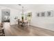 Dining room features a modern chandelier and an open concept design leading to the living room at 379 W Dragon Tree Ave, Queen Creek, AZ 85140