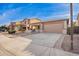 Charming single-story home with desert landscaping and a two-car garage at 379 W Dragon Tree Ave, Queen Creek, AZ 85140