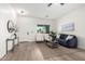 Bright living area with a large window, modern furniture, and light hardwood floors at 379 W Dragon Tree Ave, San Tan Valley, AZ 85140