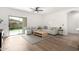 Bright living room featuring a ceiling fan, neutral decor, and sliding glass doors to the backyard at 379 W Dragon Tree Ave, San Tan Valley, AZ 85140