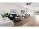 Bright living area with a large window, modern furniture, and light hardwood floors at 379 W Dragon Tree Ave, San Tan Valley, AZ 85140