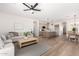 Open-concept living space with a kitchen island, stainless steel appliances, and neutral color palette at 379 W Dragon Tree Ave, San Tan Valley, AZ 85140