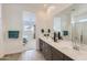 Modern bathroom with dual sinks, a large mirror, and a shower with glass doors at 3794 E Terrel St, San Tan Valley, AZ 85143