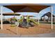 Colorful playground with slides and climbing structures under shaded canopies in a community park at 3794 E Terrel St, San Tan Valley, AZ 85143