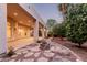 Stone lined beds and pathing surround this backyard patio that includes a fire pit and mature fruit trees at 3954 E Florian Ave, Mesa, AZ 85206