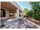 Stunning outdoor living space with covered patio, stone fire pit, and lush landscaping at 3954 E Florian Ave, Mesa, AZ 85206