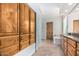 Bathroom features tile floors, glass block window, wooden cabinets, and separate tub at 3954 E Florian Ave, Mesa, AZ 85206