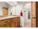 Bathroom featuring a wooden vanity, and a view to a walk-in closet and a toilet at 3954 E Florian Ave, Mesa, AZ 85206