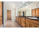 Bathroom with granite countertop, tile floors, wooden cabinets, and a separate tub at 3954 E Florian Ave, Mesa, AZ 85206