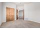 Bedroom with neutral carpet, an open doorway, and wooden doors to other rooms at 3954 E Florian Ave, Mesa, AZ 85206