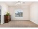 Bedroom features neutral carpet, a ceiling fan, and a large window with shutters at 3954 E Florian Ave, Mesa, AZ 85206