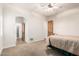 Bedroom with a brass bed, ceiling fan, carpet floor and open entry to the closet at 3954 E Florian Ave, Mesa, AZ 85206