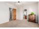 Bedroom features neutral carpet, wooden doors, and open doorway to the bathroom at 3954 E Florian Ave, Mesa, AZ 85206