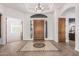 Bright foyer featuring tile flooring, a decorative medallion, and a wood front door with side windows at 3954 E Florian Ave, Mesa, AZ 85206