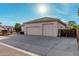 Spacious three-car garage with a large driveway and well-maintained exterior at 3954 E Florian Ave, Mesa, AZ 85206