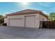 A wide shot of the house's garage shows a three-car garage with a wide driveway and a well-maintained exterior at 3954 E Florian Ave, Mesa, AZ 85206